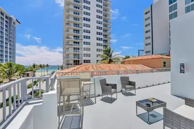 a balcony with chairs and a view of the ocean at Eden Escape Walk to FLT Beach 1201 in Fort Lauderdale