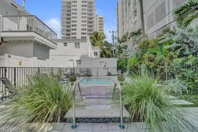 a pool in the middle of a courtyard with plants at Eden Escape Walk to FLT Beach 1105 in Fort Lauderdale