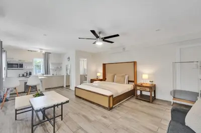 a large bedroom with a bed and a kitchen at Eden Escape Walk to FLT Beach 2204 in Fort Lauderdale