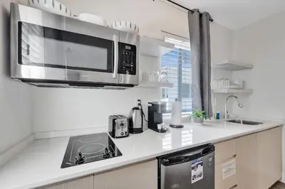 a kitchen with a stove and a microwave at Eden Escape Walk to FLT Beach 2204 in Fort Lauderdale