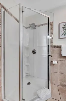 a shower with a glass door in a bathroom at Eden Escape Walk to FLT Beach 1206 in Fort Lauderdale