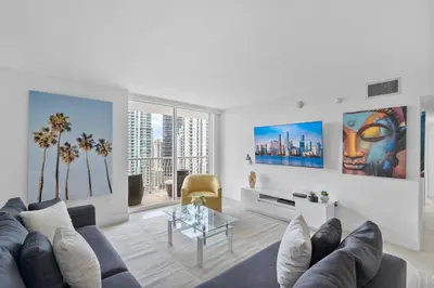 a living room with a couch and a table at Stunning 3Bedroom 34th Floor Brickell Free Parking in Miami