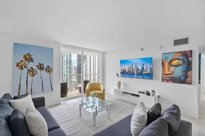a living room with a couch and a table at Stunning 3Bedroom 34th Floor Brickell Free Parking in Miami