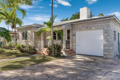 a stone house with a garage at Casa de Jai- your Green Space near Brickell in Miami