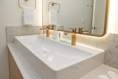 a bathroom with a white sink and a mirror at Deluxe 2 bed with Amazing views in Miami