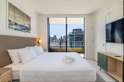 a bedroom with a large white bed with a large window at Deluxe 2 bed with Amazing views in Miami