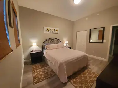 a bedroom with a bed with two night stands and two lamps at Beautiful Mediterranean Oceanfront Condo with Private Beach in Hallandale Beach