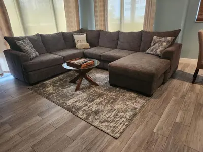 a living room with a couch and a coffee table at Beautiful Mediterranean Oceanfront Condo with Private Beach in Hallandale Beach