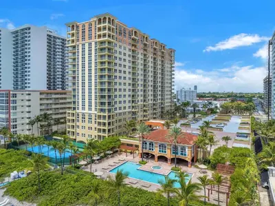 an aerial view of a large apartment building with a pool at Beautiful Mediterranean Oceanfront Condo with Private Beach in Hallandale Beach