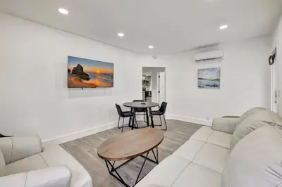 a living room with a couch and a table at Banyan St 2BR 1BA off Las Olas Steps to Beach 1 in Fort Lauderdale