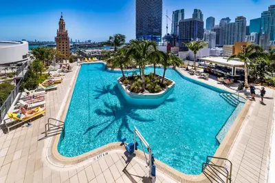 an overhead view of a large swimming pool with a city skyline at Magnificent 3 Bedrooms in Downtown Miami with incredible views in Miami