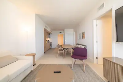 a living room with a white couch and a purple chair at Magnificent 3 Bedrooms in Downtown Miami with incredible views in Miami