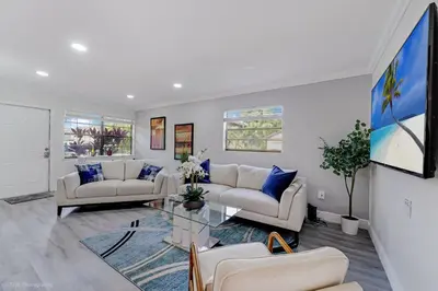 a living room with two couches and a glass table at Spacious 4BR Miami Townhome with Communal Pool in Ives Estates