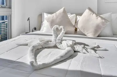 a swan made out of towels on a bed at Stylish Studio and Den Across from Bayside Miami in Miami