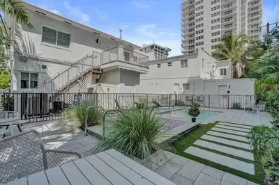an apartment patio with a white building and a staircase at Eden Escape 1 BR 2202 Walk to FLT Beach in Fort Lauderdale