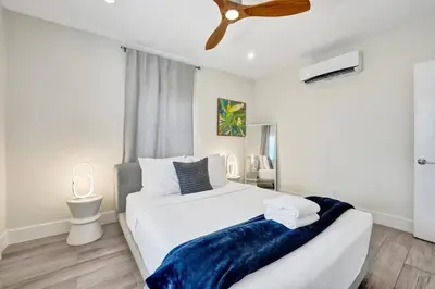 a bedroom with a large white bed and a ceiling fan at Eden Escape Studio 2103 Walk to FLT Beach in Fort Lauderdale