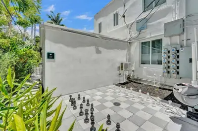 a chess game on a patio in front of a building at Eden Escape Studio 2103 Walk to FLT Beach in Fort Lauderdale