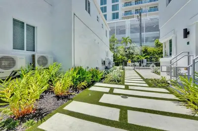 a garden with plants and stairs in a building at Eden Escape Studio 2103 Walk to FLT Beach in Fort Lauderdale