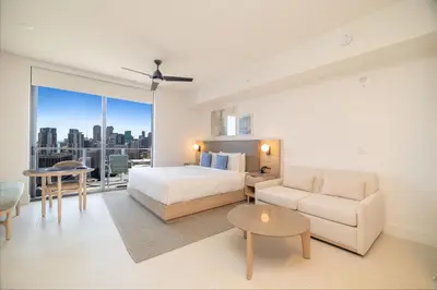 a bedroom with a bed and a couch and a table at Extraordinary Studio in Downtown Miami with incredible views in Miami