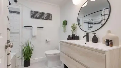 a bathroom with a sink and a mirror at Luxury Waterfront Home w Pool Hot Tub Dock Near Las Olas Gulfstream in Fort Lauderdale