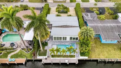 an aerial view of a house with palm trees at Luxury Waterfront Home w Pool Hot Tub Dock Near Las Olas Gulfstream in Fort Lauderdale