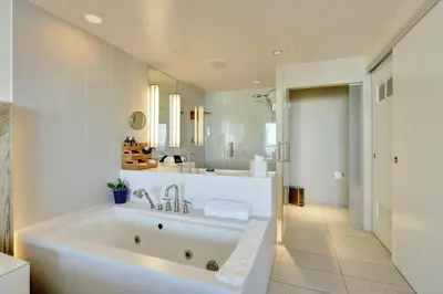 a large white bathroom with a tub and a sink at Beach Club - Oceanfront Luxury, Resort Amenities, Balcony Views in Fort Lauderdale