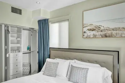 a bedroom with a white bed and a window at Villa Monaco in Miami Beach