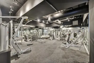 a gym with several treadmills and machines at Beachside Condo with Resort Amenities, Including Pools, Gym, and Bathtub 503 in Miami Beach