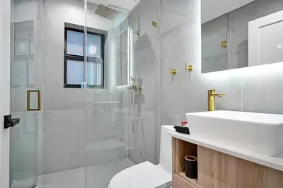 a bathroom with a shower and a sink and a toilet at Tropical Guest House at VIlla Verde Miami in Miami