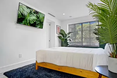 a white bedroom with a bed and a window at Private Suite At Villa Verde Miami in Miami