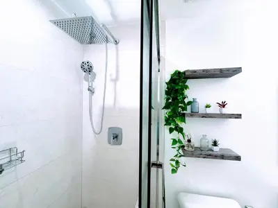 a white bathroom with a shower and a toilet at Modern Bedroom In Central Miami Shared with host in Miami