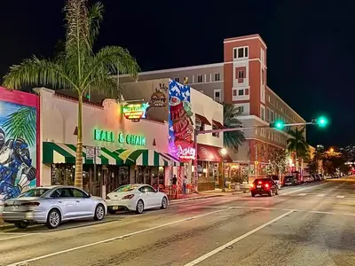 a city street at night with cars stopped at a traffic light at Modern Bedroom In Central Miami Shared with host in Miami