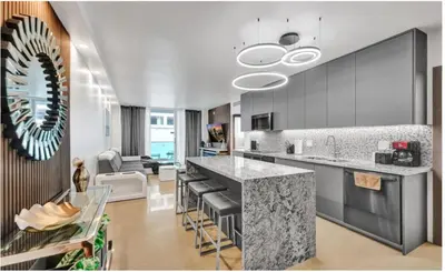 a kitchen with a counter and a living room at Luxury Oceanfront 2 Bedroom ON THE BEACH 3 FLOOR in Hollywood