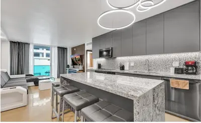 a kitchen with a counter and a living room at Luxury Oceanfront 2 Bedroom ON THE BEACH 3 FLOOR in Hollywood