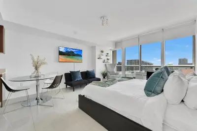 a bedroom with a large bed and a table and chairs at Luxury Unit W Residences Brickell in Miami