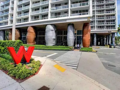 a large building with a red sign in front of it at Luxury Unit W Residences Brickell in Miami