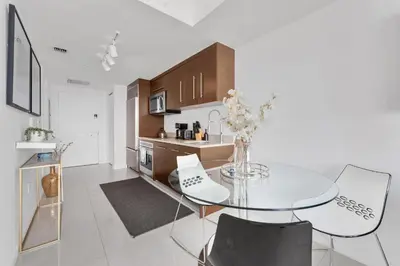 a kitchen with a glass table and some chairs at Luxury Unit W Residences Brickell in Miami