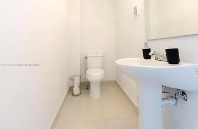 a white bathroom with a sink and a toilet at 3BR Townhouse, Miami and the Keys in Homestead