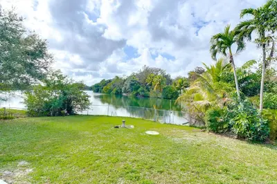 a park with a body of water and palm trees at 8 Mi to Wynwood Waterfront Retreat with Lanai in Miami