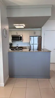 a kitchen with a counter and a refrigerator at Breathtaking Direct Bay Views 2 bedroom condo with parking in Miami