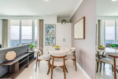 a dining room with a table and chairs and windows at 2 bedroom Bay View Beauty in Coconut Grove- Parking for 2 cars included! in Miami