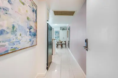 a hallway with a painting on the wall and a table at Bay View Beauty 1 Bedroom condo in Coconut Grove Parking Included in Miami
