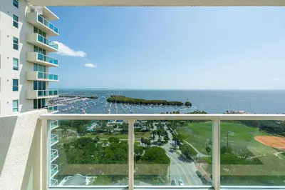 a view of the ocean from the balcony of a building at Bay View Beauty 1 Bedroom condo in Coconut Grove Parking Included in Miami
