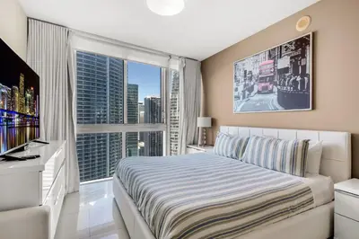 a bedroom with a bed and a large window at Icon brickell The W hotel residence in Miami