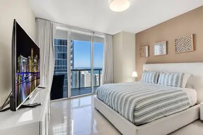 a bedroom with a bed and a large window at Icon brickell The W hotel residence in Miami