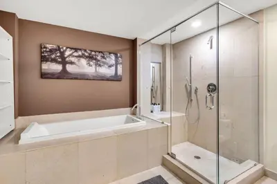 a bathroom with a tub and a glass shower at Icon brickell The W hotel residence in Miami