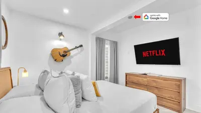 a bedroom with a bed with a guitar on the wall at Miami Designer Apartment Unit 2 in Miami