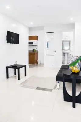 a white living room with a black table at Miami Designer Apartment Unit 1 in Miami