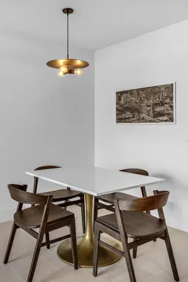 a dining room table with chairs and a chandelier at Hotel 601 in Miami