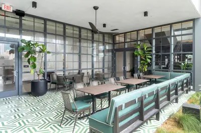 a restaurant with tables and chairs and windows at Hotel 601 in Miami